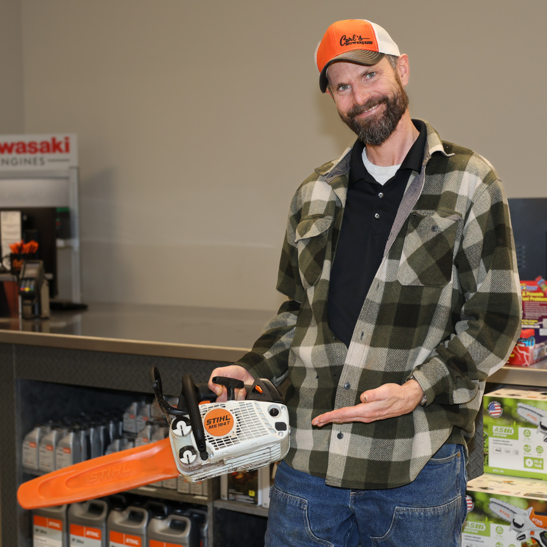 Nick smiling and holding a STIHL MS 194 T chainsaw